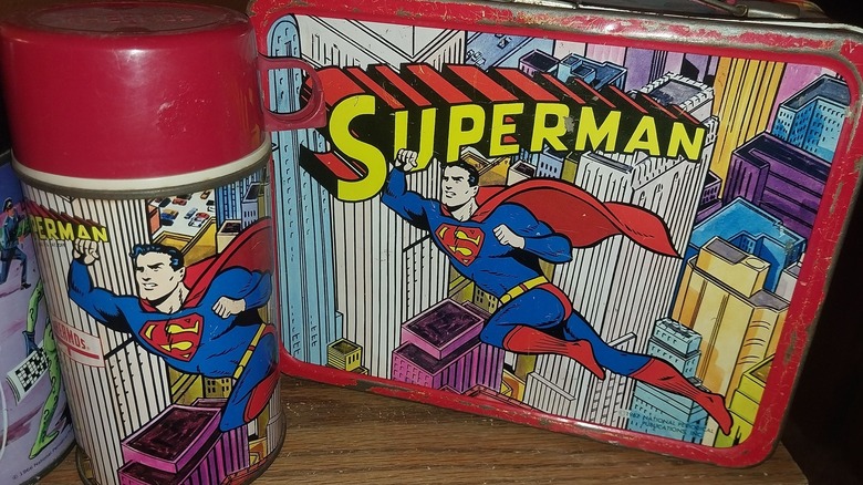 A vintage Superman metal lunch box and matching Thermos flask