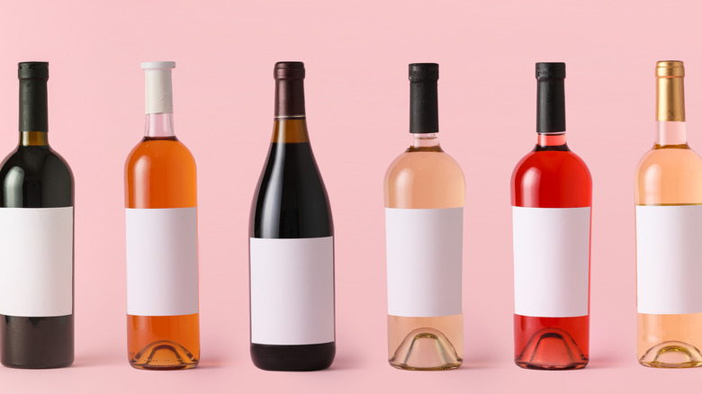 bottles of wine against a pink background