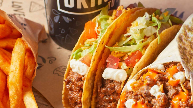 Taco Bell Volcano burrito next to two crunchy tacos