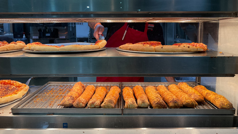 Costco food warmers full of bread and pizzas