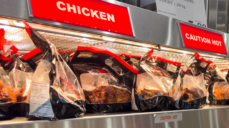 Costco Kirkland Signature cooked rotisserie chickens on display inside hot case