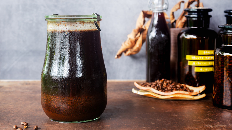 A jar of homemade cold brew coffee steeping using the immersion method