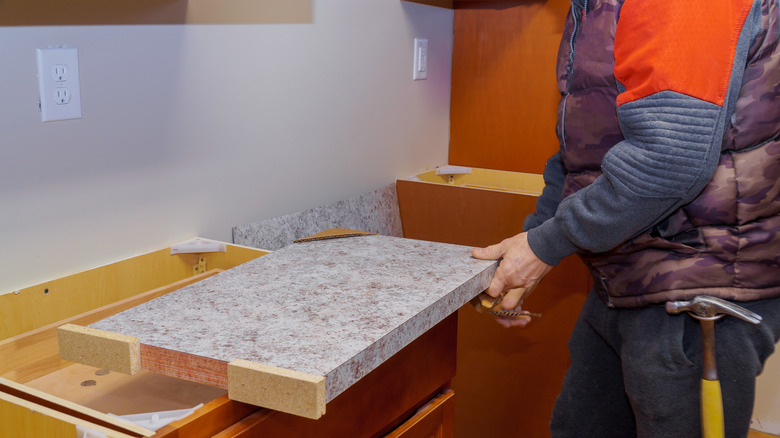 worker installing laminate countertop