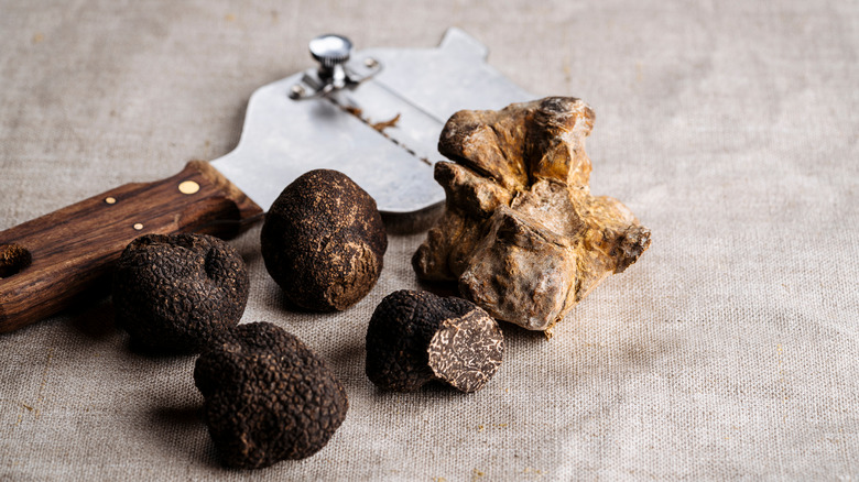 black truffles being shaved