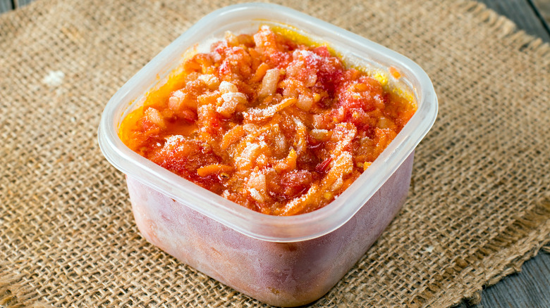 frozen tomato sauce in plastic container