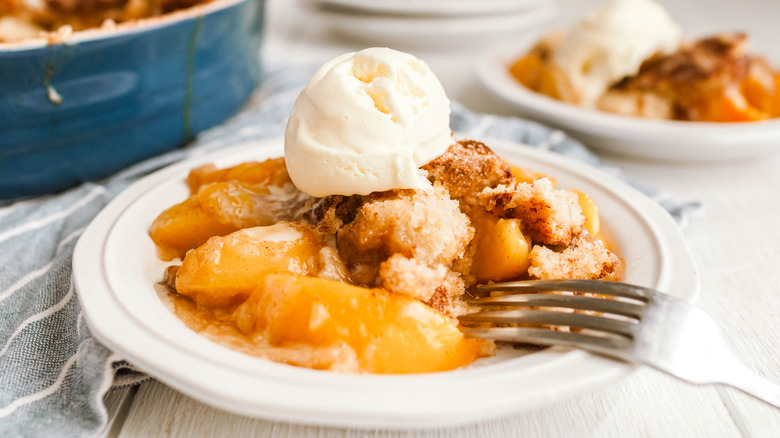plate of peach cobbler with ice cream