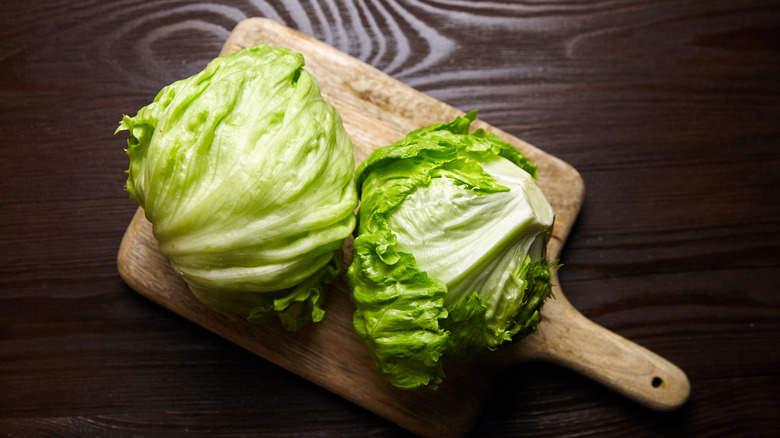 heads of lettuce on cutting board