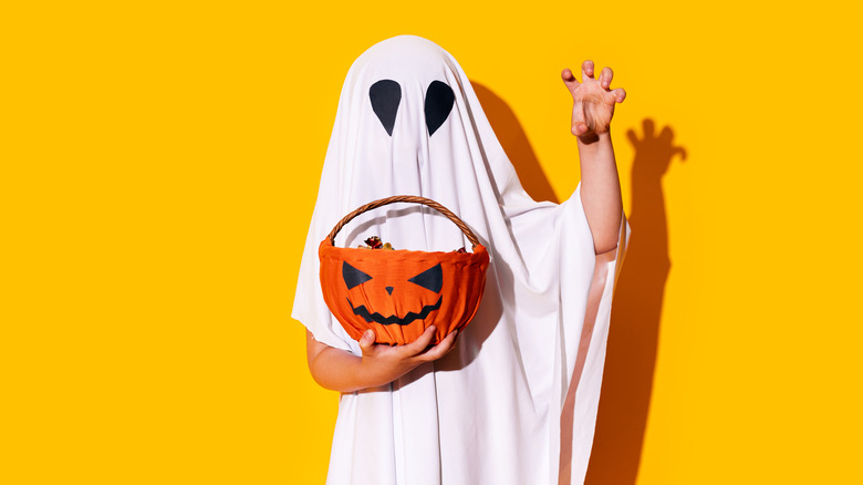 child dressed as Halloween ghost