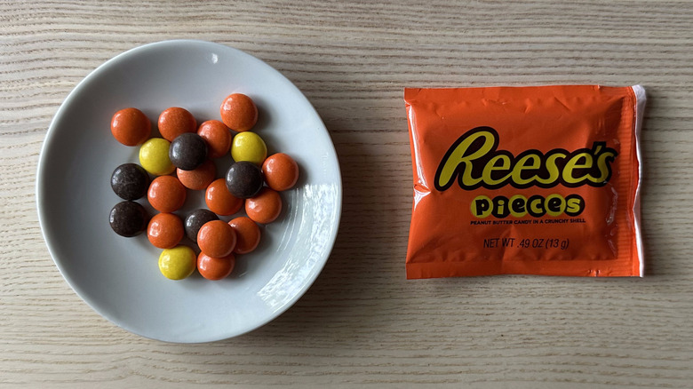 Reese's Pieces on wooden table