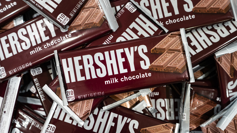 A pile of Hershey's Milk Chocolate Candy bars lie in a pile