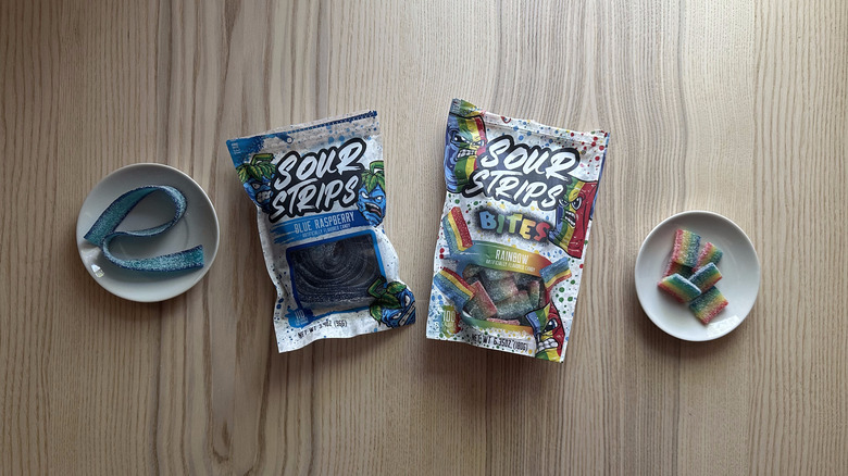 Bags of Sour Strips on wooden table