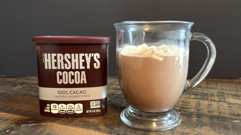 Hershey's cocoa powder hot chocolate in glass mug on wooden table