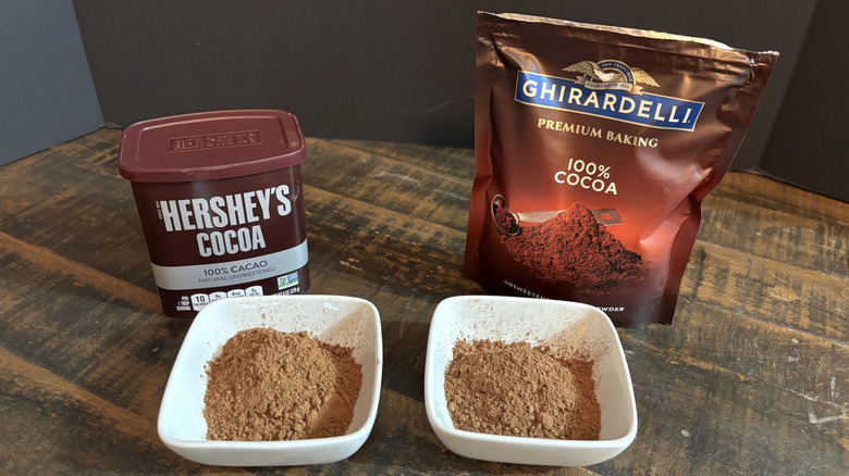 Hershey's and Ghirardelli cocoa powder in white bowls on wooden table