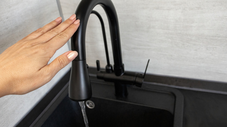 Person using touchless faucet