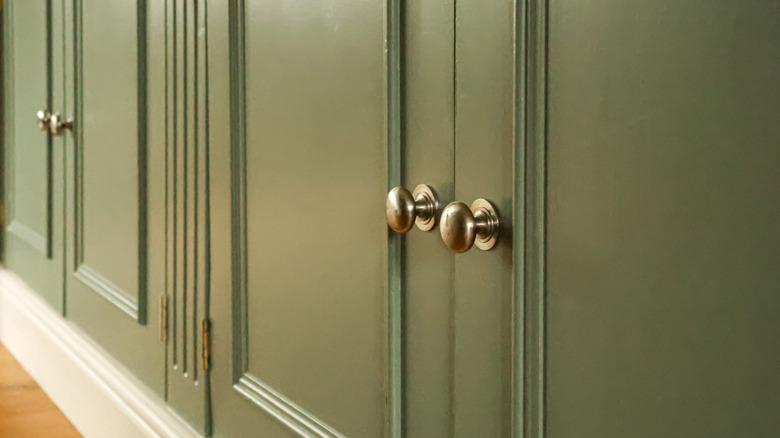Close up of green kitchen cabinets