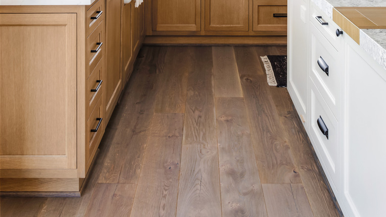 Kitchen with wood cabinets and white counters with two large open windows