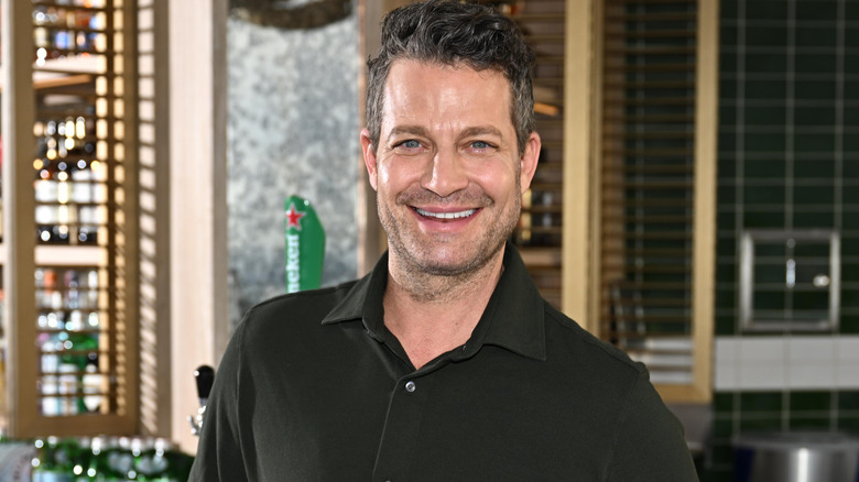 Nate Berkus posing aboard a luxury cruise ship in 2022