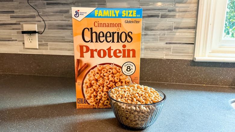 A box and bowl of Cheerios Protein cereal are shown.