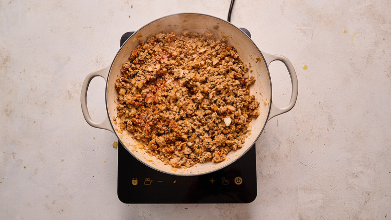cooking tomato paste into turkey mixture