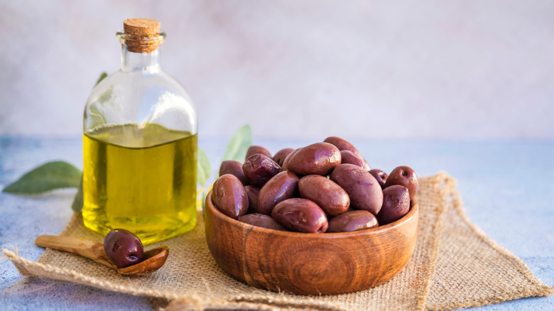 Bowl of olives and small bottle of olive oil