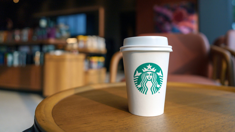 to go Starbucks cup on cafe table