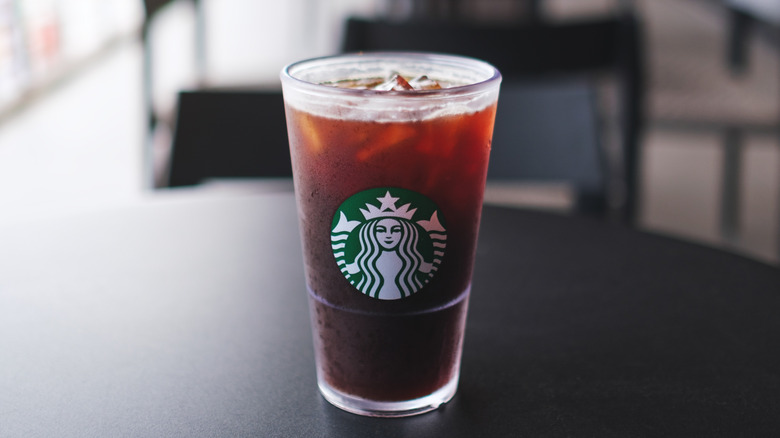 A Starbucks iced drink sitting on a black table