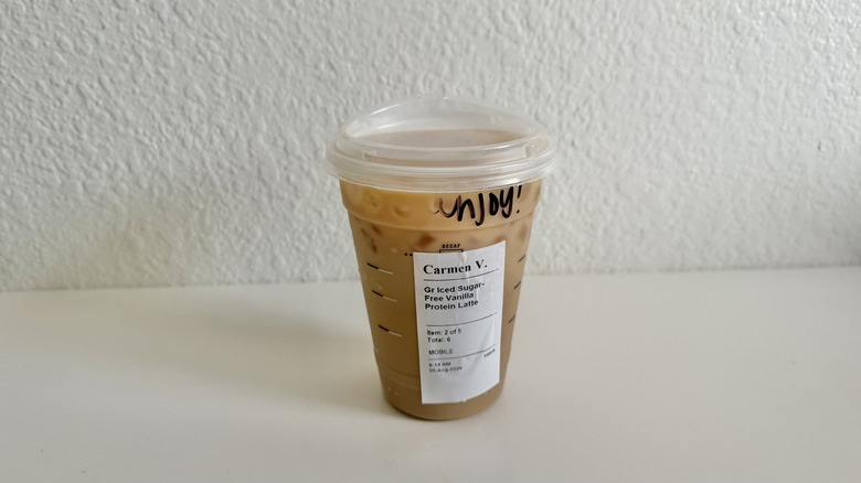 Starbucks' Sugar-Free Vanilla Protein Iced Latte sitting on a table