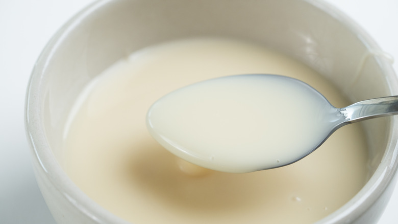close up of condensed milk on spoon