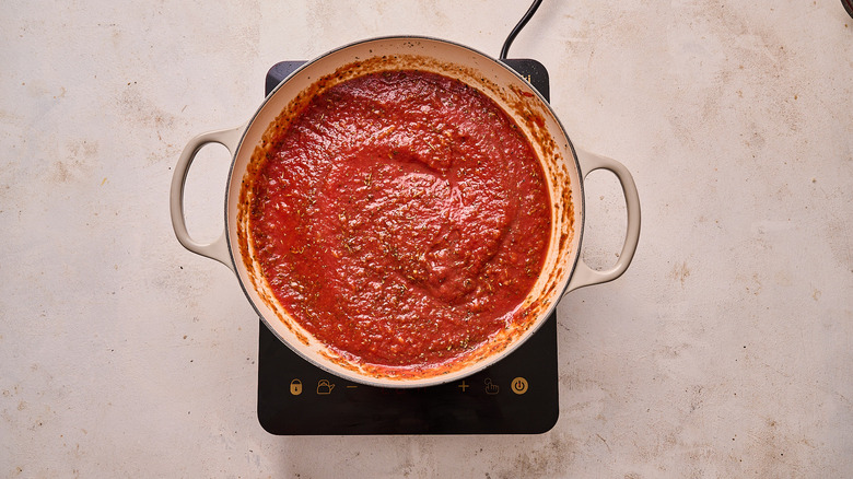 simmering tomato sauce in a skillet