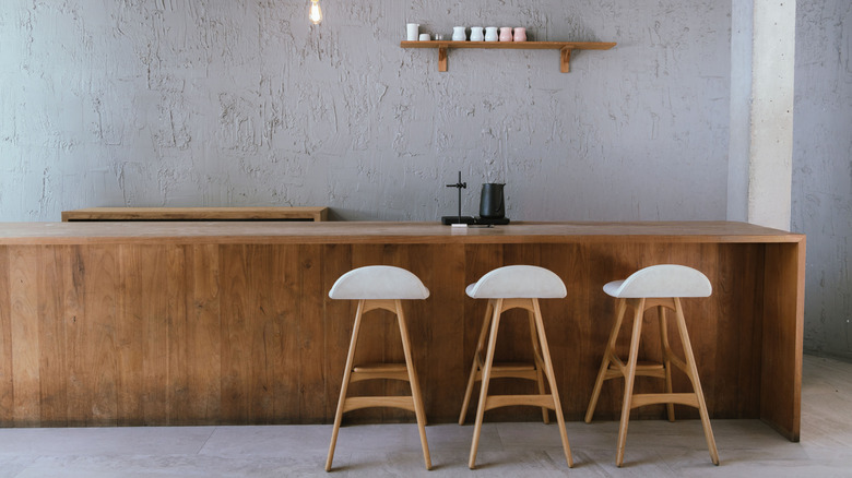 Minimalist bar counter with stools