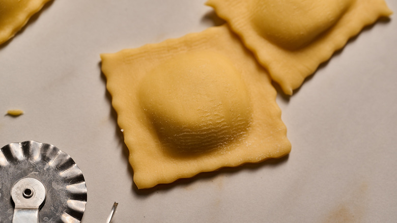 uncooked cheese ravioli on a table