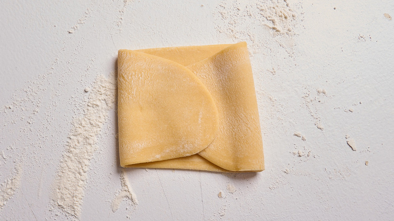 folding each side of the dough in towards the center
