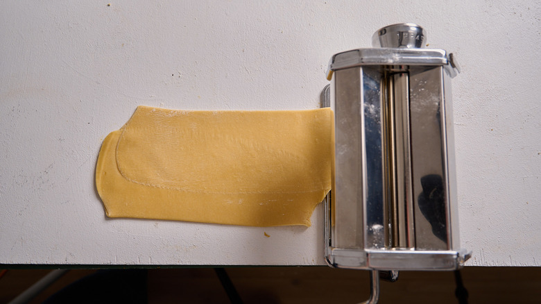 rolling the folded dough through the machine