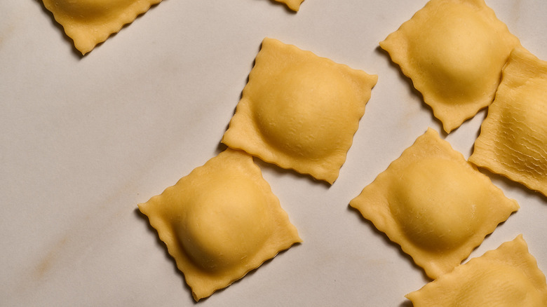 cut squares of ravioli on a table