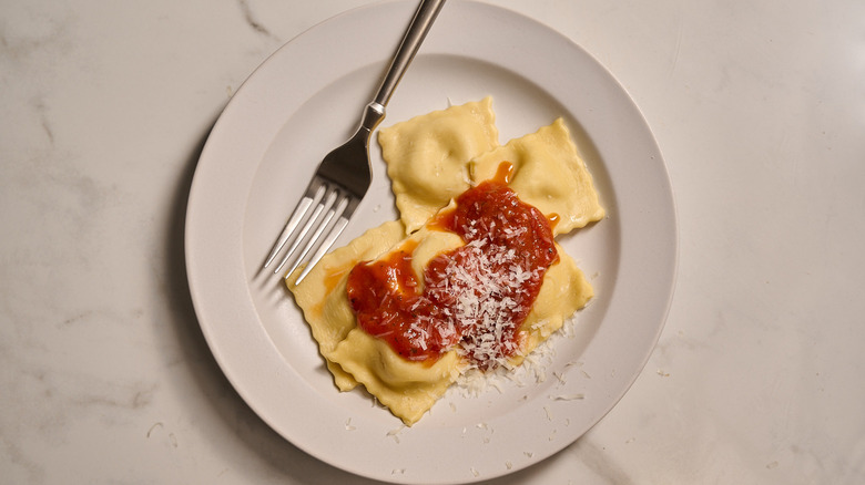 ravioli plated with sauce