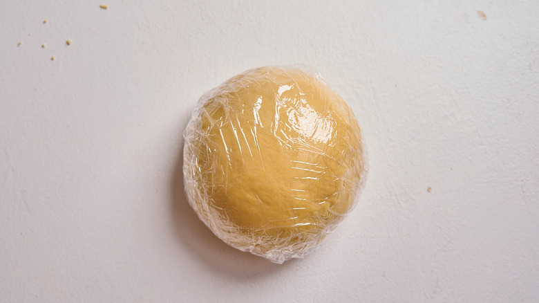 dough ball wrapped in plastic