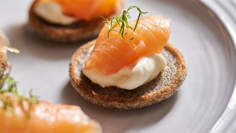blini with salmon and dill on plate