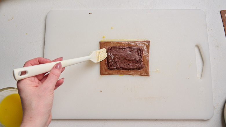 brushing pop tart with egg wash