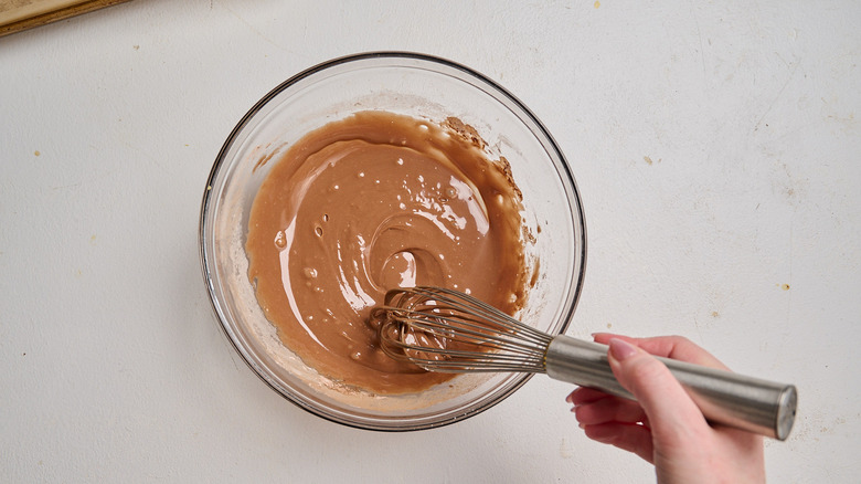 whisking icing ingredients together in a bowl