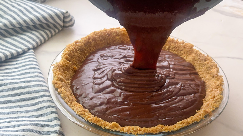 pudding pouring into pie crust