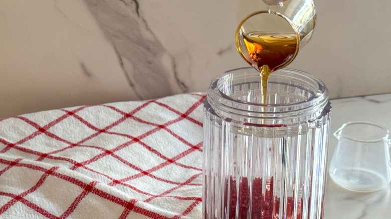 pouring maple syrup into blender
