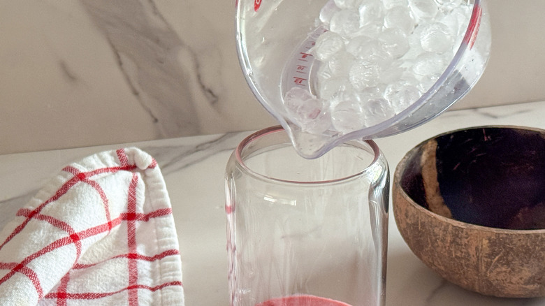 adding ice to glass