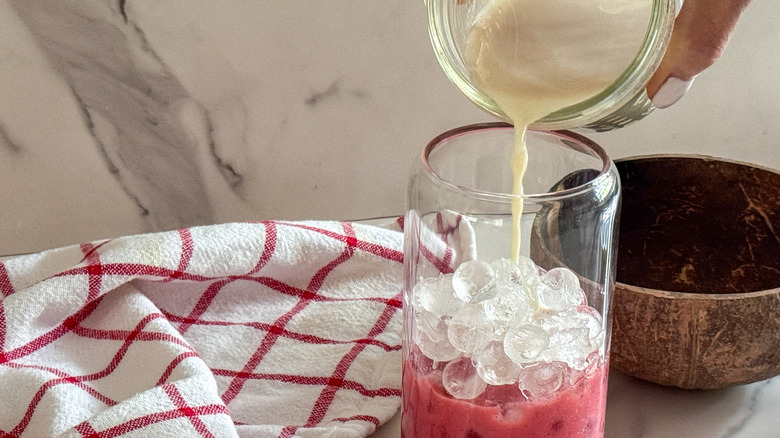 adding milk to glass