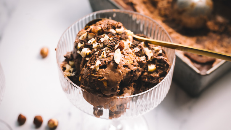 A serving of Nutella ice cream in front of container