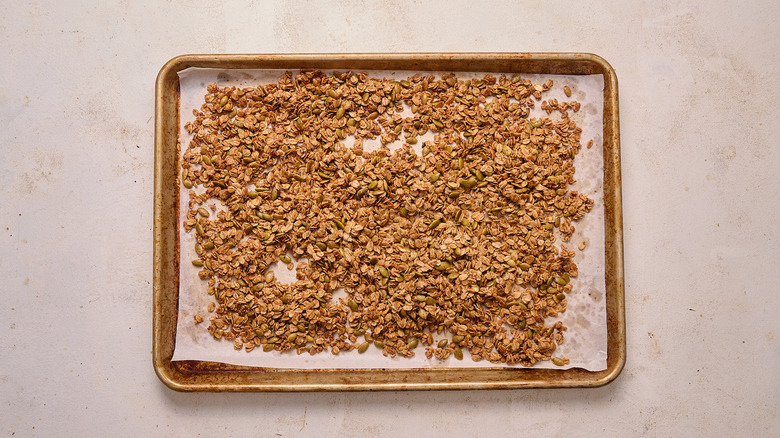 baked granola on a baking sheet