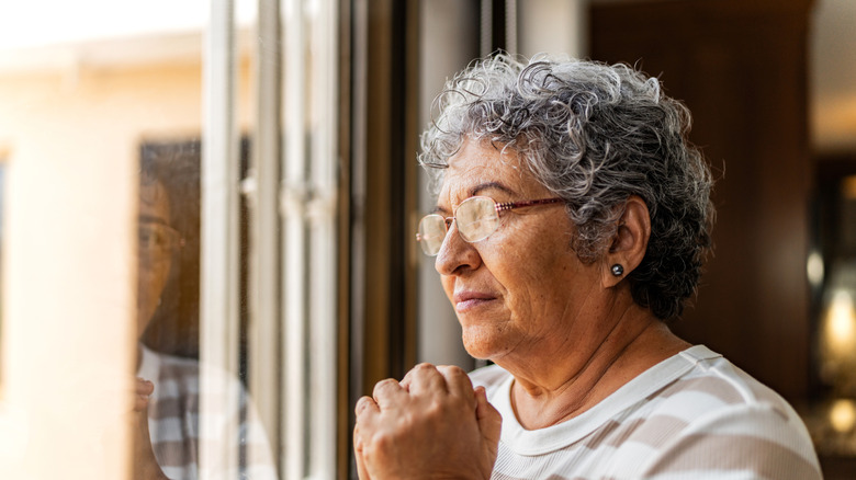 Senior woman looking out the window