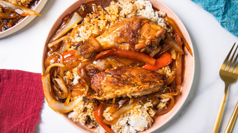 Homestyle Filipino chicken adobo stir-fry on white plate over rice