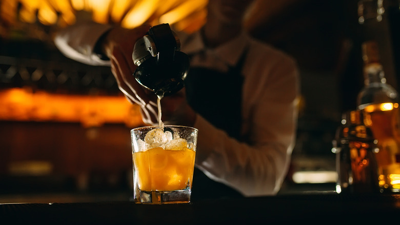 bartender preparing whiskey cocktail