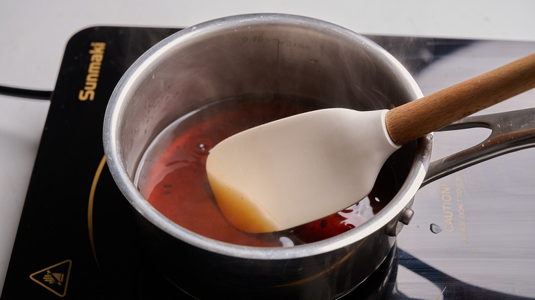 dissolving sugar in hot water in a saucepan