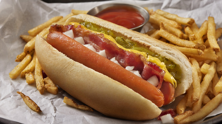 hot dog in bun with ketchup, mustard, and relish